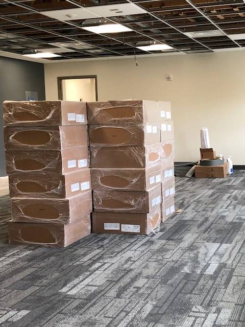 A stack of boxes in a room under construction.